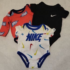 Three Nike onesies/bodysuits
